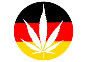 Deutschlandfahne in Kreisform, ausgeschnitten in weiß der Umriss eines Cannabisblattes